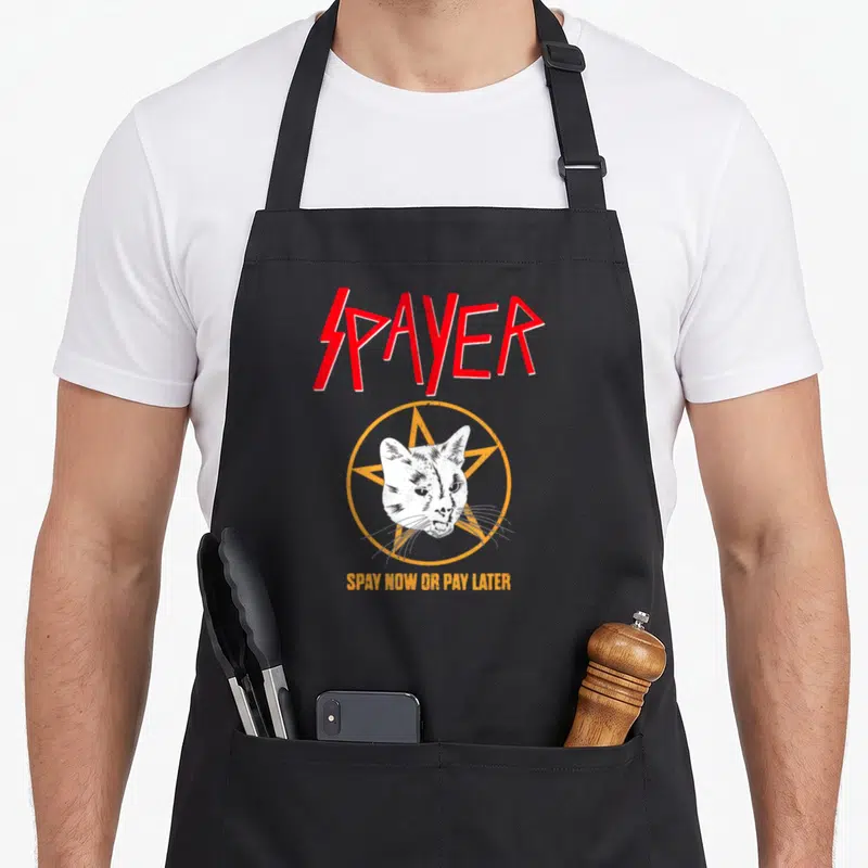 Spayer cat apron - Red spayer text over white cat head in orange pentagram with bottom slogan — shown on a black cotton canvas apron against a white background