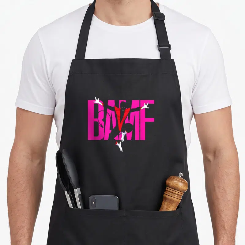 Nightcrawler x apron - Cartoon character emerging from pink BAMF text with red coat and white hands — shown on a black cotton canvas apron against a white background