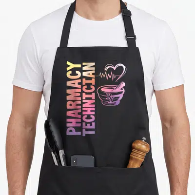 Technician pharmacist apron - Vertical PHARMACY TECHNICIAN text next to a heart, EKG line, and mortar with Rx symbol — shown on a black cotton canvas apron against a white background