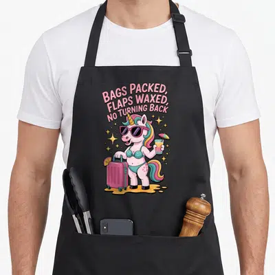 Embarrassing travel aprons - Cartoon unicorn in teal bikini holding pink suitcase and drink under arched pink text — shown on a black cotton canvas apron against a white background