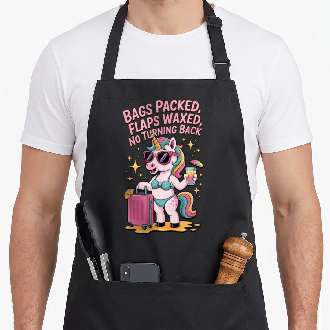 Embarrassing travel aprons - Cartoon unicorn in teal bikini holding pink suitcase and drink under arched pink text — shown on a black cotton canvas apron against a white background