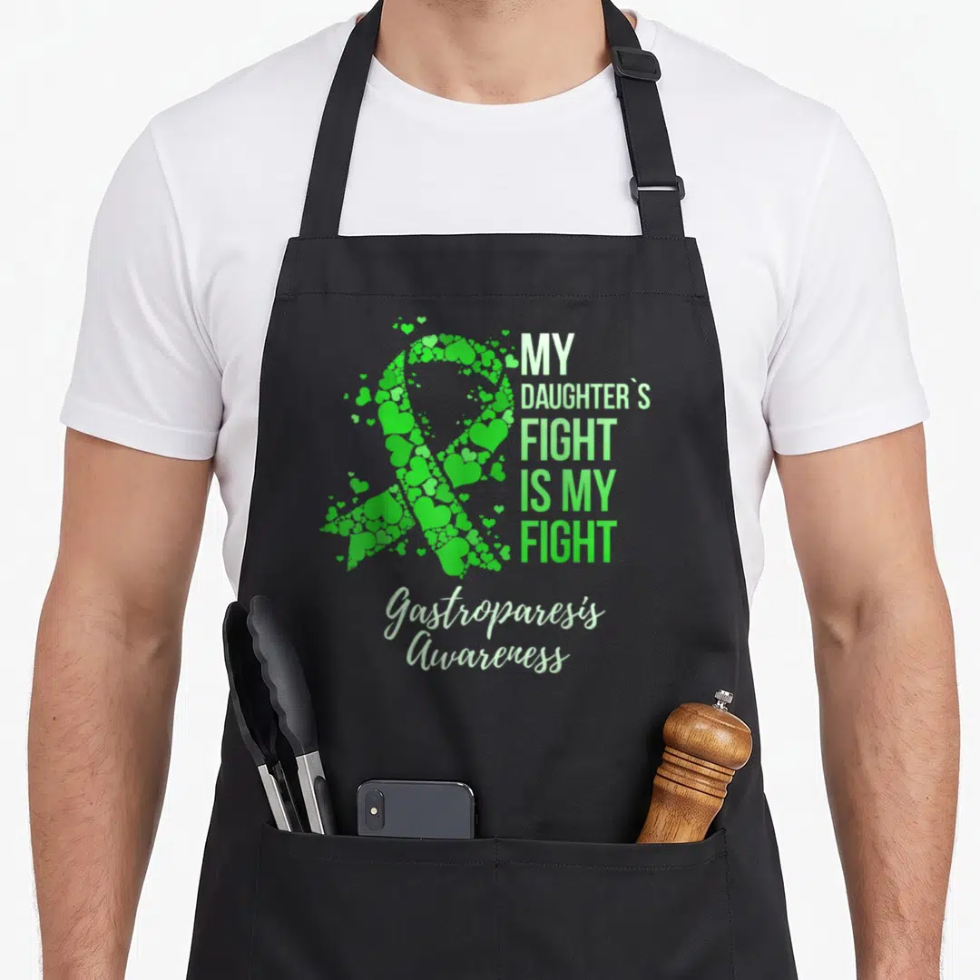 Daughter gastroparesis awareness apron - Green ribbon made of hearts next to stacked text reading My Daughters Fight Is — shown on a black cotton canvas apron against a white background