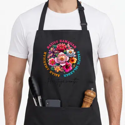 Islander month asian apron - Colorful floral bouquet with Native Hawaiian Pacific Islander Asian American Heritage — shown on a black cotton canvas apron against a white background