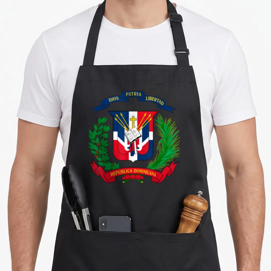 Coat dominican apron - Coat of Arms Republica Dominicana shield with blue red white yellow and green details and ribbon — shown on a black cotton canvas apron against a white background
