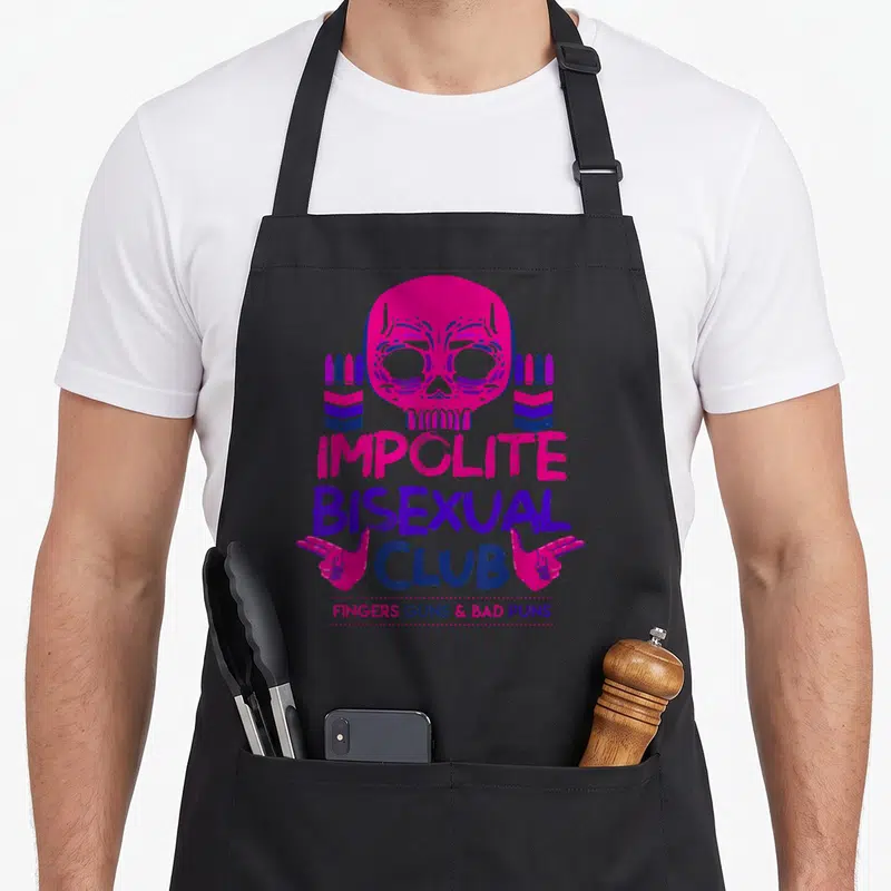Boredkoalas pride apron - Pink skull and finger guns with Impolite Bisexual Club text in flag colors — shown on a black cotton canvas apron against a white background