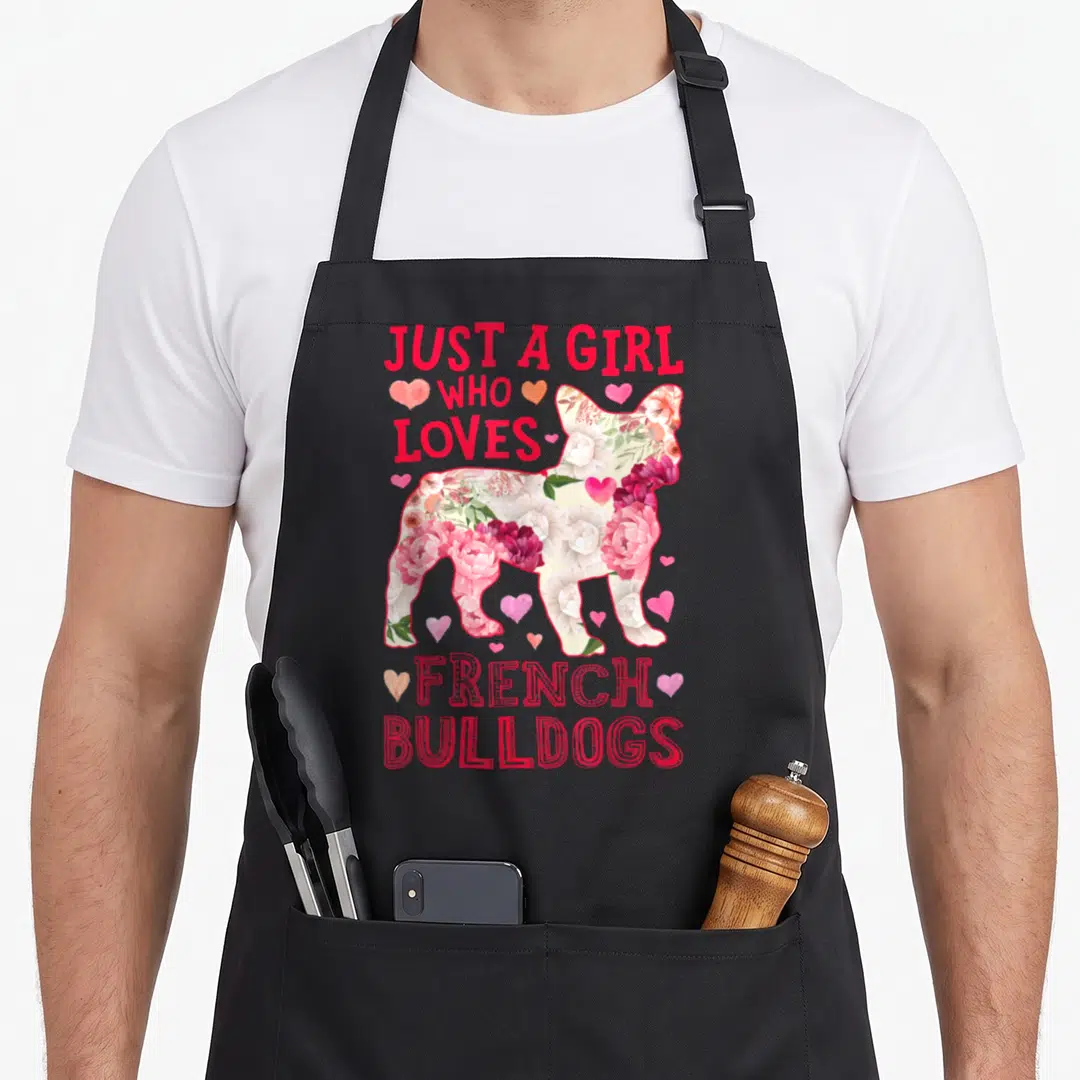 Dog french apron - Floral French Bulldog silhouette with red text Just A Girl Who Loves French Bulldogs and pink hearts — shown on a black cotton canvas apron against a white background