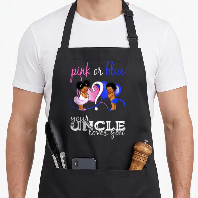Uncle apron or apron - Two cartoon babies flank a white question mark under pink and blue text on a black apron — shown on a black cotton canvas apron against a white background