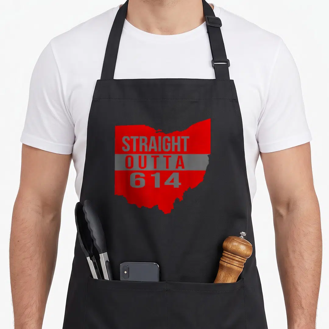 Straight columbus apron - Red Ohio state silhouette with stacked grey STRAIGHT OUTTA 614 text over a grey horizontal — shown on a black cotton canvas apron against a white background