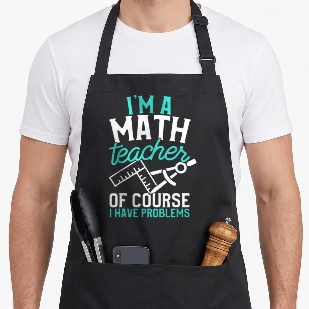 Savvy teacher apron - Turquoise and white text I'm a math teacher of course I have problems with ruler and compass — shown on a black cotton canvas apron against a white background