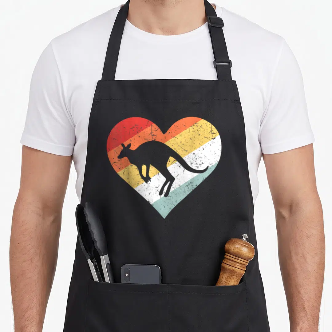 80s gday kangaroo apron - Grey kangaroo silhouette inside a heart with red orange yellow white and light blue stripes — shown on a black cotton canvas apron against a white background