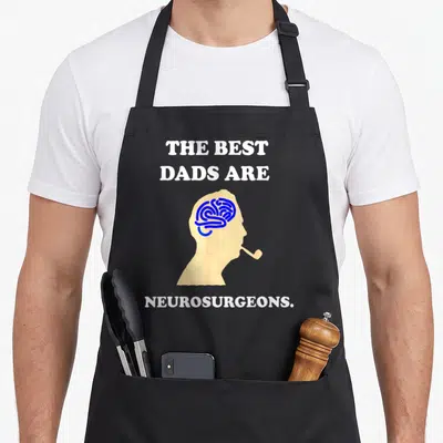 Neurosurgeon doctor with apron - Beige head silhouette with blue brain and white text reading THE BEST DADS ARE — shown on a black cotton canvas apron against a white background