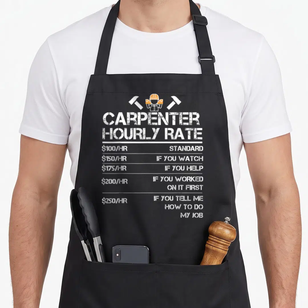 Hourly wood apron - Carpenter hourly rate chart with hammers and distressed white text — shown on a black cotton canvas apron against a white background
