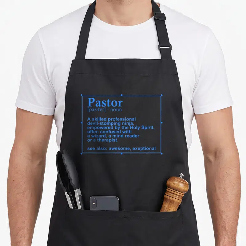 Definition christian apron - Blue dictionary definition of Pastor describing a devil-stomping ninja empowered — shown on a black cotton canvas apron against a white background