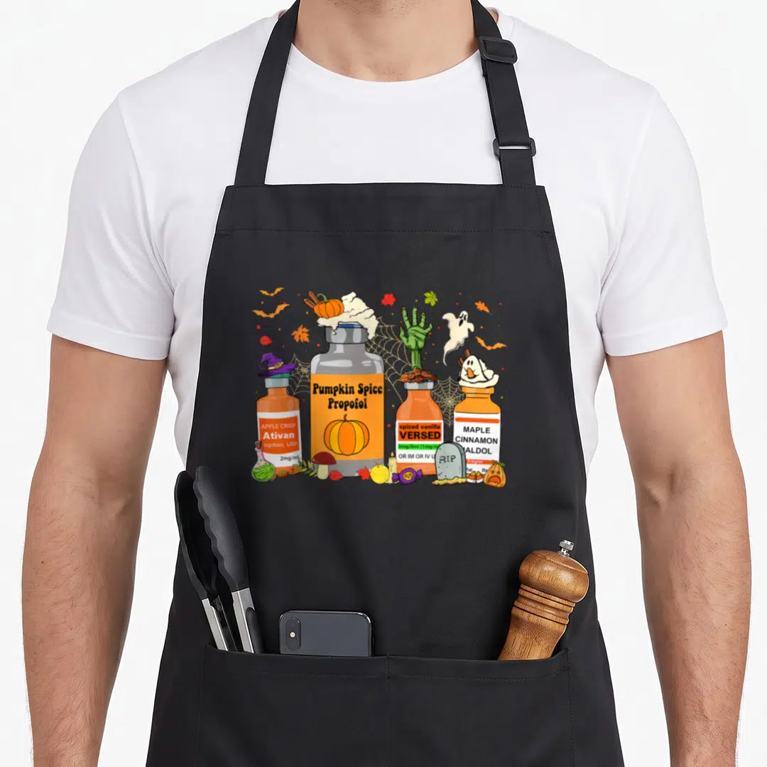 Propofol spice apron - Four cartoon medicine bottles labeled Pumpkin Spice Propofol and Maple Cinnamon Haldol — shown on a black cotton canvas apron against a white background