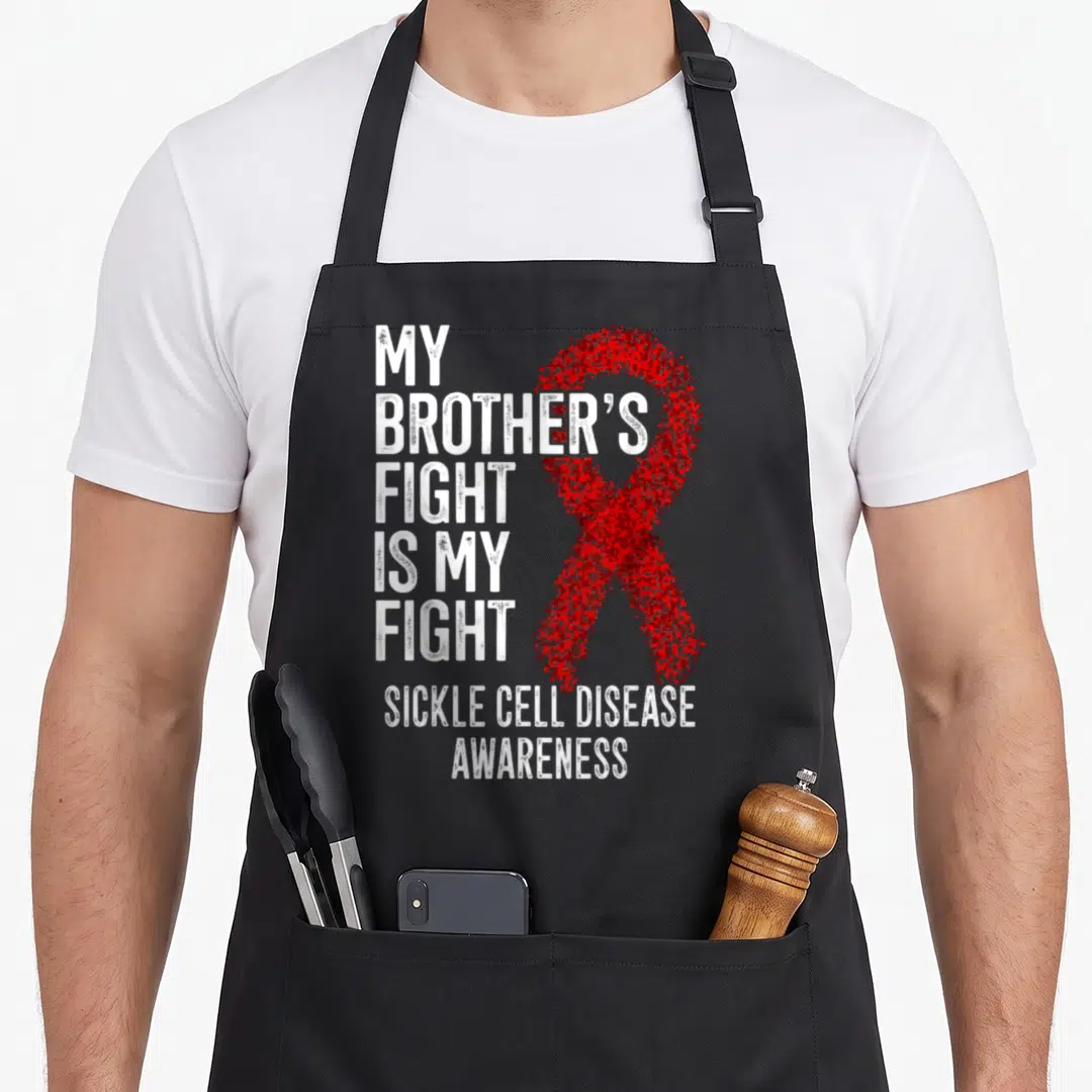 Brother sickle cell awareness apron - Red stippled ribbon and white distressed text reading MY BROTHERS FIGHT IS MY — shown on a black cotton canvas apron against a white background