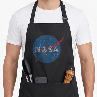 Cute distressed nasa apron - Distressed blue NASA logo with red swoosh and white stars — shown on a black cotton canvas apron against a white background