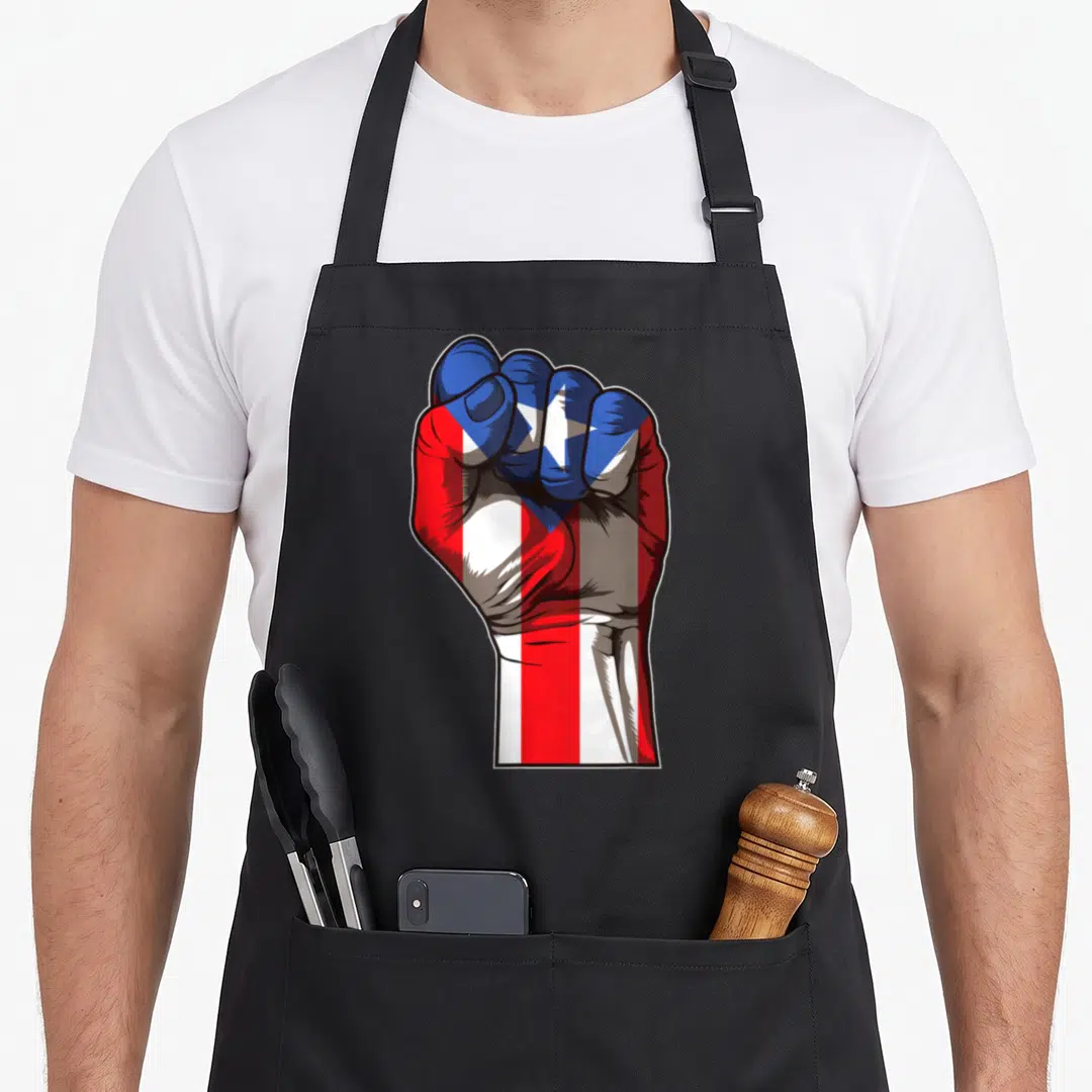 Raised pride apron - Clenched fist filled with red white and blue flag pattern facing forward — shown on a black cotton canvas apron against a white background