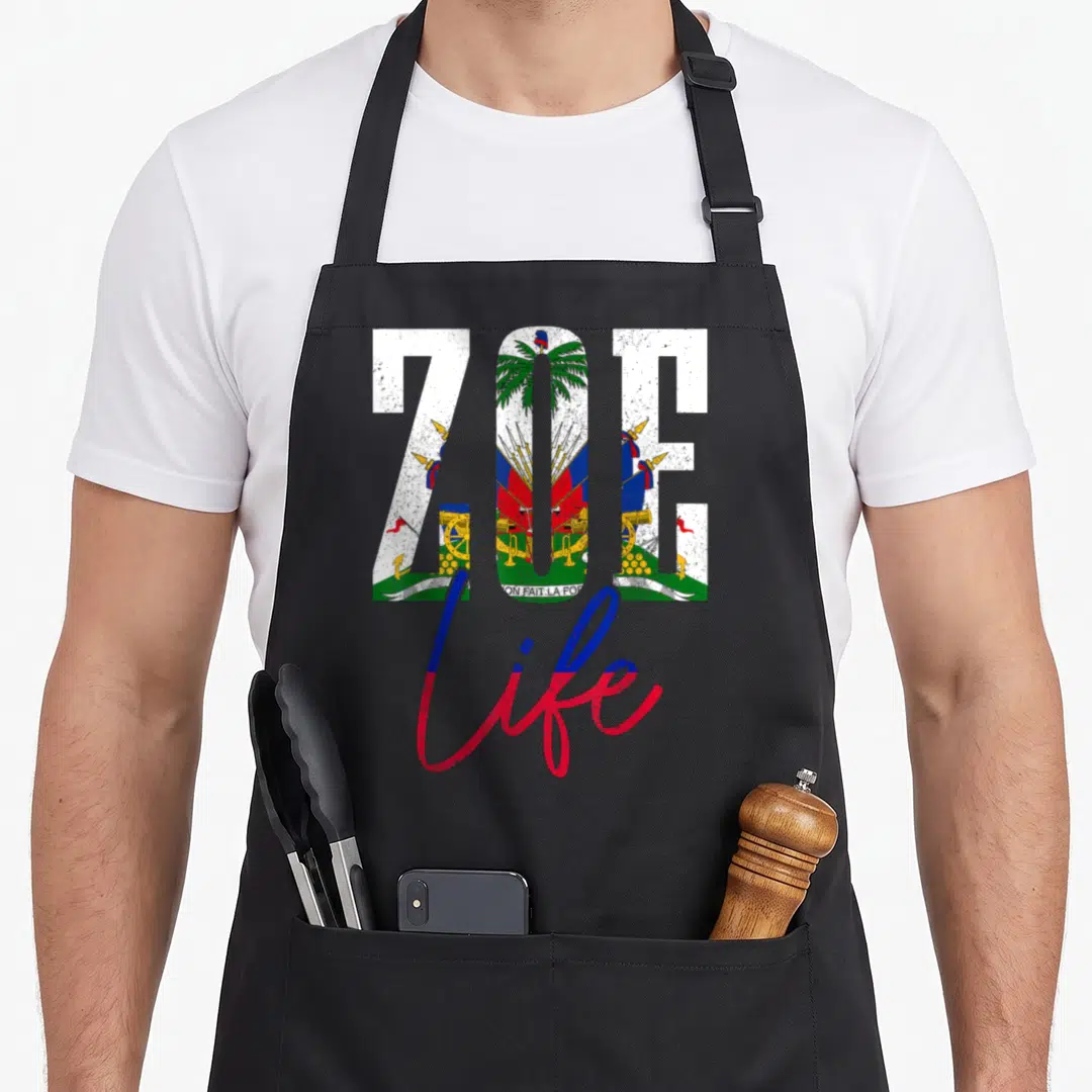 Haiti haitian apron - ZOE filled with Haitian coat of arms, L'UNION FAIT LA FORCE ribbon, and life script in distressed — shown on a black cotton canvas apron against a white background