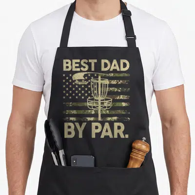 Disc camo apron - Best Dad By Par text over disc golf basket and camo flag — shown on a black cotton canvas apron against a white background