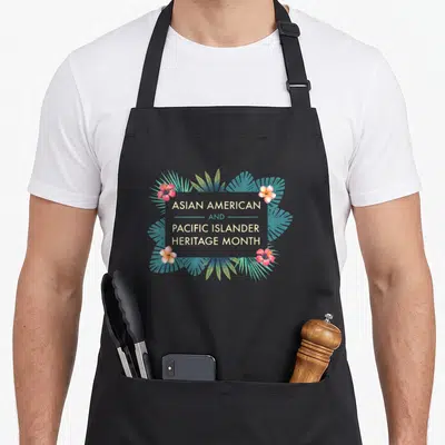 Pacific islander heritage asian apron - Centered text ASIAN AMERICAN AND PACIFIC ISLANDER HERITAGE MONTH framed by teal — shown on a black cotton canvas apron against a white background