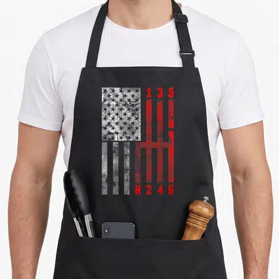 Stick muscle apron - Distressed USA flag merged with red 1-6 and R manual gear shift pattern — shown on a black cotton canvas apron against a white background