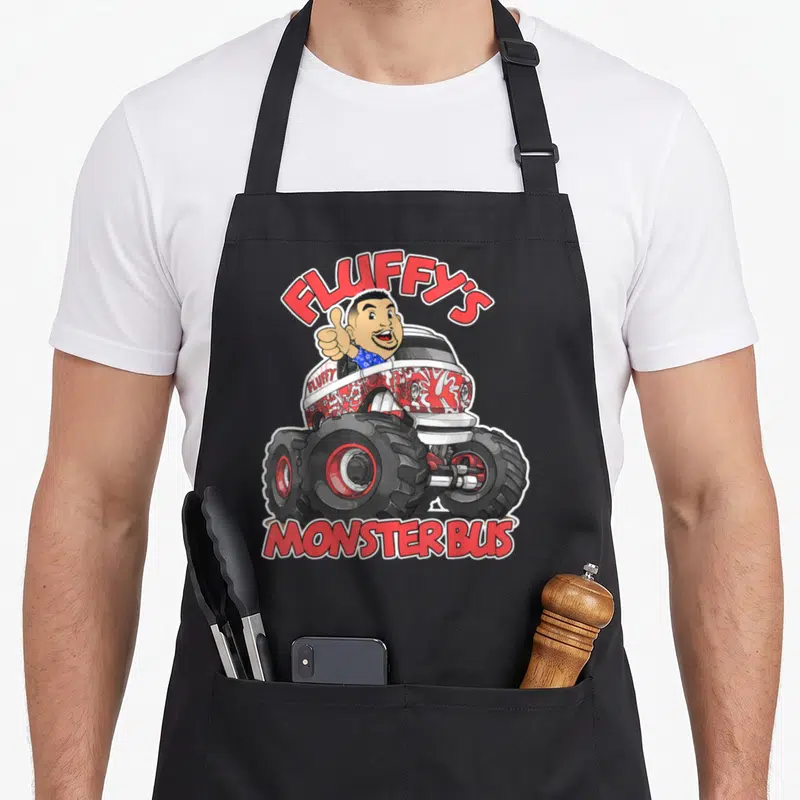 Gabriel truck aprons - Cartoon man thumbs up in red white monster bus with Fluffy's Monster Bus text — shown on a black cotton canvas apron against a white background