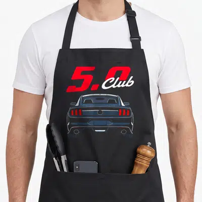 Coyote car apron - Red 5.0 Club text above a blue car rear view illustration — shown on a black cotton canvas apron against a white background