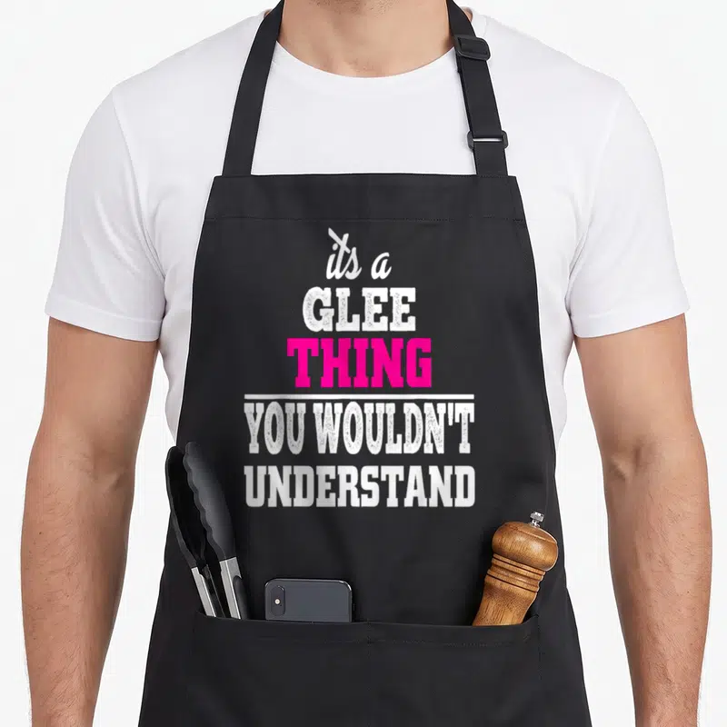 Funny glee club apron - Stacked white and pink text reading its a GLEE THING YOU WOULDNT UNDERSTAND — shown on a black cotton canvas apron against a white background