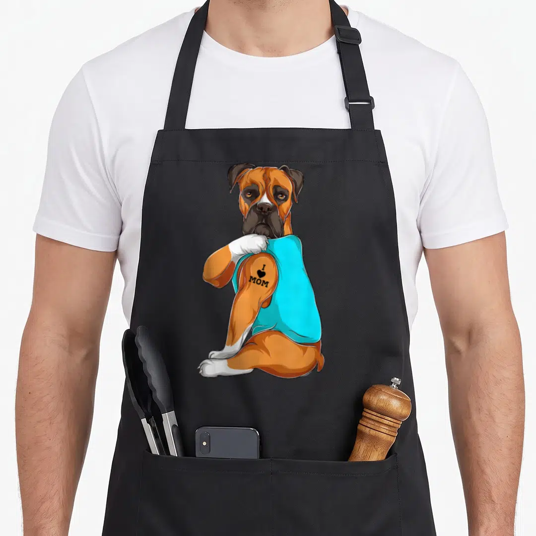 Tattoo boxer dog apron - Brown boxer in cyan shirt with tattoo reading I love mom on right arm — shown on a black cotton canvas apron against a white background