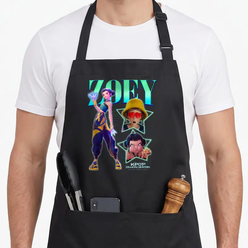 Zoey trend apron - ZOEY K-POP DEMON HUNTERS character with star frames and teal blue yellow purple art — shown on a black cotton canvas apron against a white background
