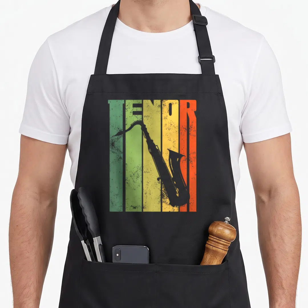Perfect saxophone apron - Grey TENOR text and sax silhouette over vertical green, yellow, orange, and red stripes — shown on a black cotton canvas apron against a white background