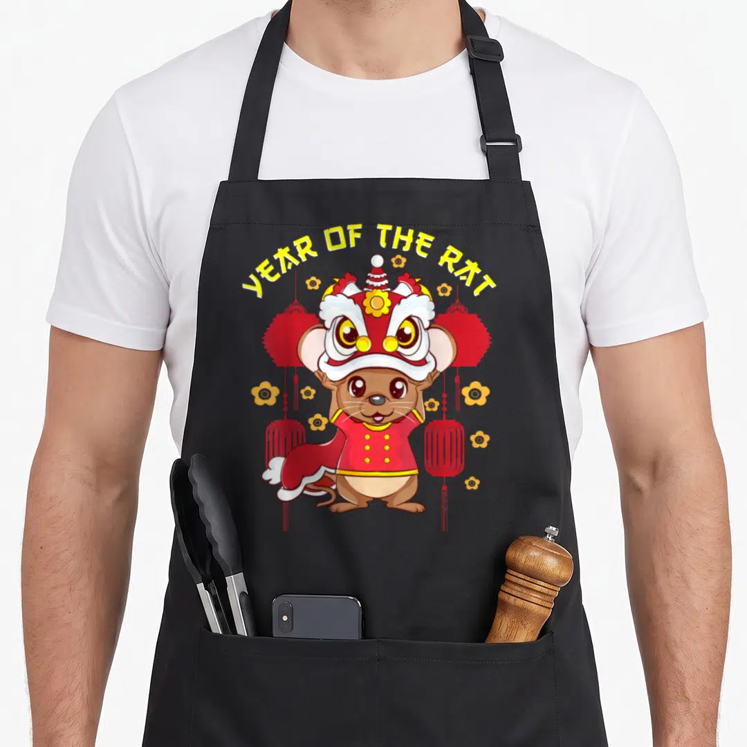 Rat lion apron - Cartoon brown rat in red lion dance mask with YEAR OF THE RAT text and lanterns — shown on a black cotton canvas apron against a white background