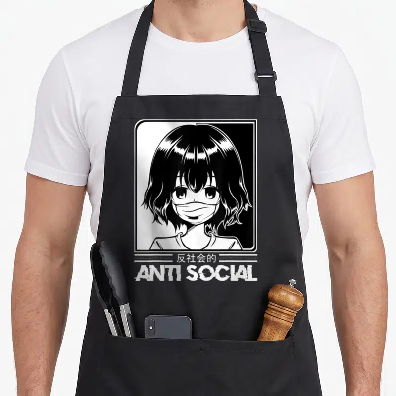 Anti japan apron - Anime girl in frame with anti social text and Japanese characters — shown on a black cotton canvas apron against a white background