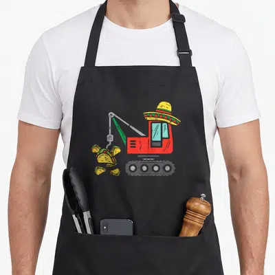 Crane mexican apron - Red excavator wearing yellow sombrero dropping tacos cartoon illustration — shown on a black cotton canvas apron against a white background