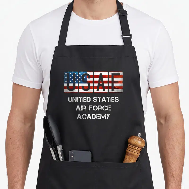 Base us aprons - USAF text filled with US flag pattern above three lines of distressed text reading United States Air — shown on a black cotton canvas apron against a white background