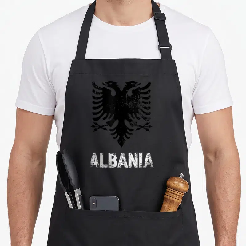 Independence eagles apron - Distressed black double-headed eagle above white ALBANIA text — shown on a black cotton canvas apron against a white background