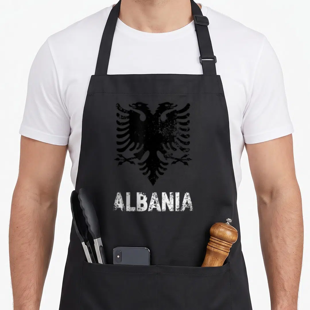 Independence eagles apron - Distressed black double-headed eagle above white ALBANIA text — shown on a black cotton canvas apron against a white background