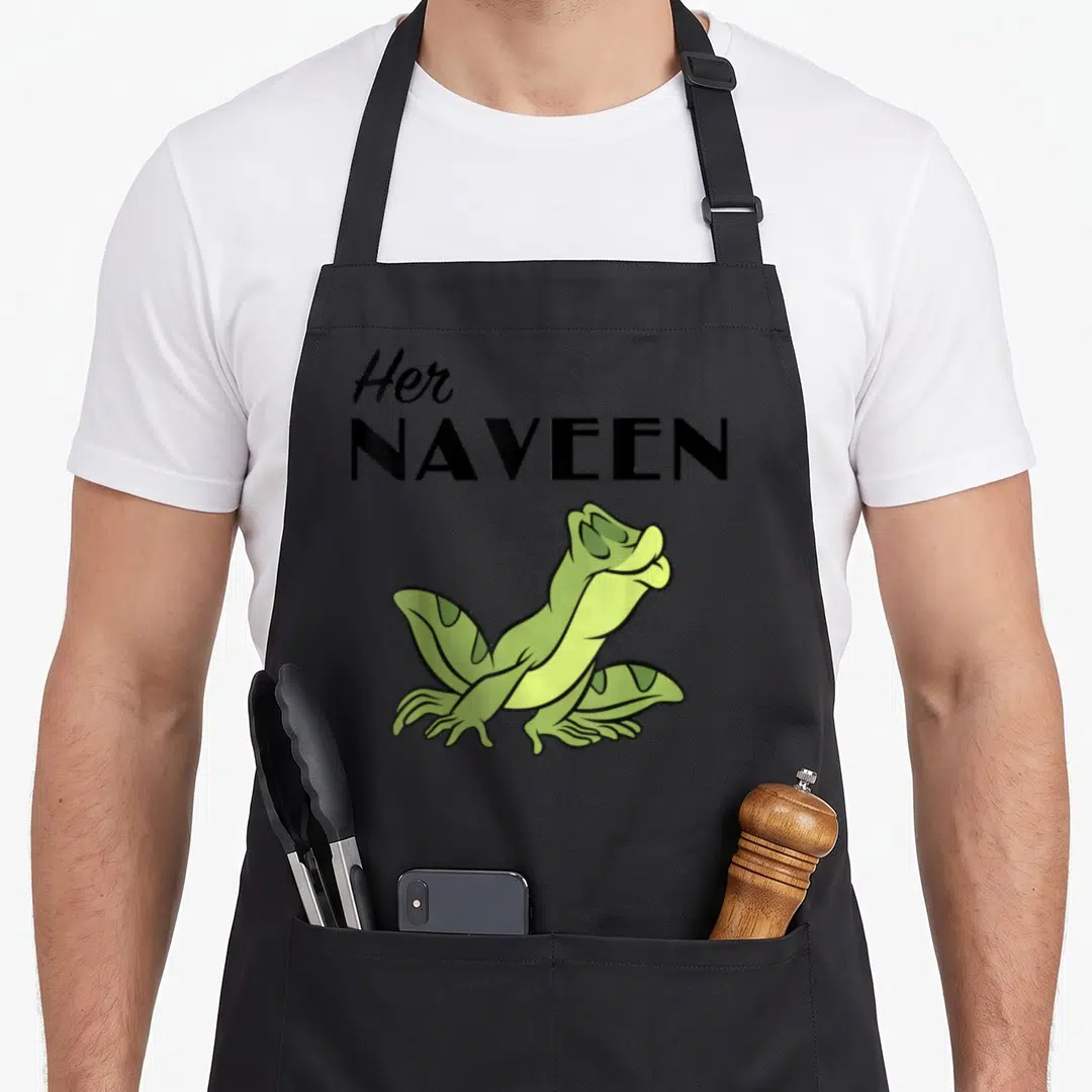 Naveen princess apron - Stacked black text Her NAVEEN above a sitting green cartoon frog — shown on a black cotton canvas apron against a white background
