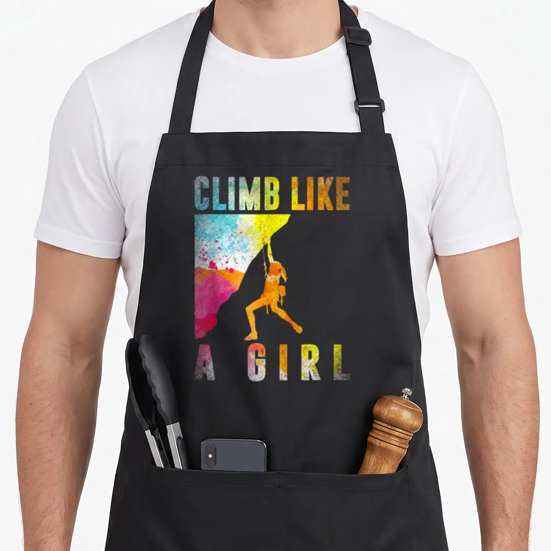 Climber bouldering apron - CLIMB LIKE A GIRL text with watercolor rock and orange climber silhouette — shown on a black cotton canvas apron against a white background