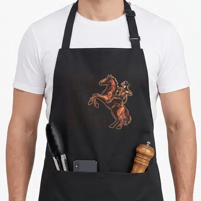 Horse country kitchen apron - Stacked GET OFF YOUR HIGH HORSE text next to a rearing brown horse with rider — shown on a black cotton canvas apron against a white background