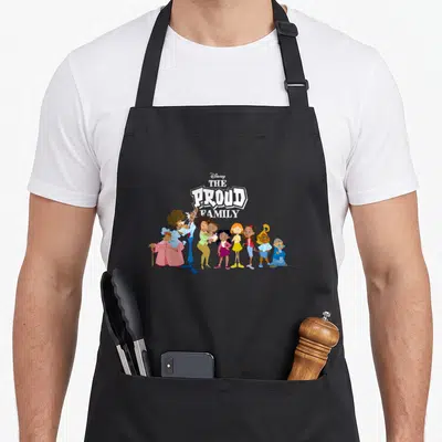 Proud family gathering apron - Disney The Proud Family logo above eight cartoon characters in white blue pink green — shown on a black cotton canvas apron against a white background