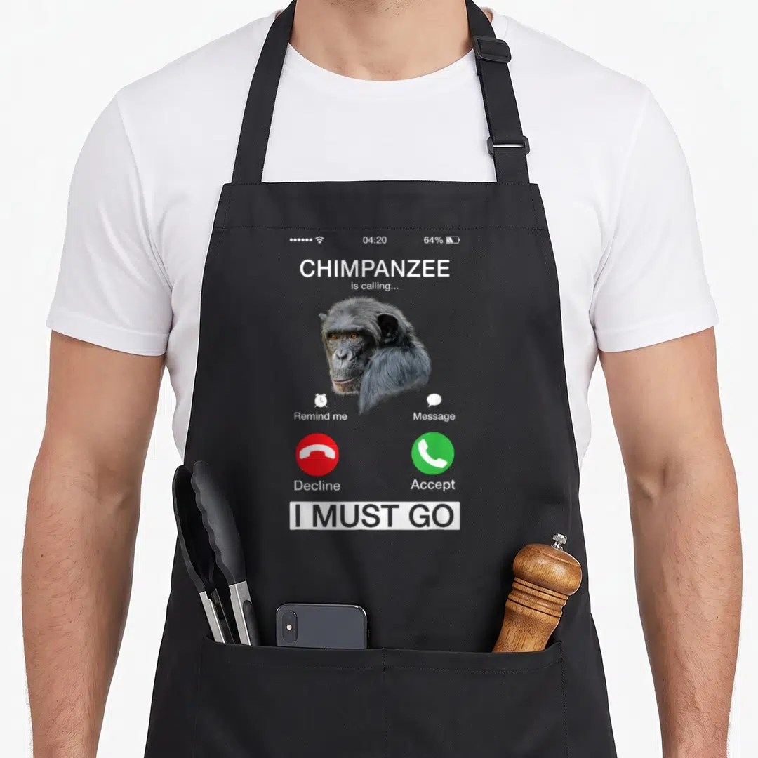 Chimpanzee call animal apron - Mock smartphone call screen with chimpanzee head, red decline button, green accept — shown on a black cotton canvas apron against a white background