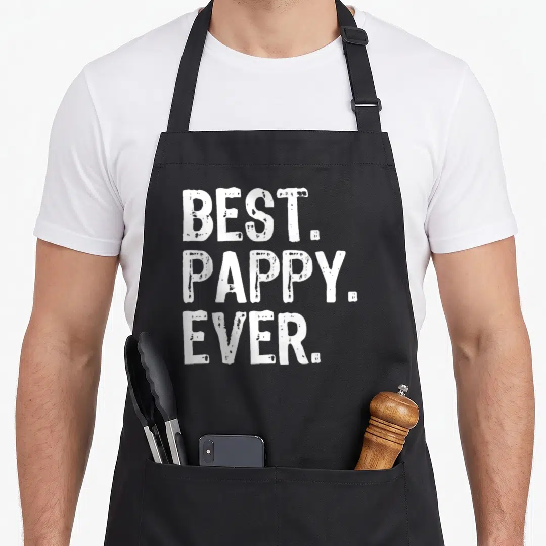 Funny pappy apron - White text BEST. PAPPY. EVER. stacked on black apron front — shown on a black cotton canvas apron against a white background