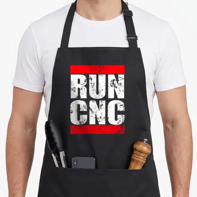 Programmer machinist apron - Distressed white RUN CNC text stacked between red horizontal bars — shown on a black cotton canvas apron against a white background