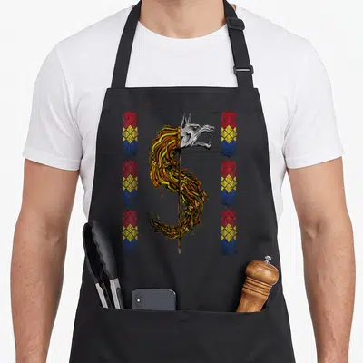 Flag romanian apron - Wolf head on pole with yellow fur and two vertical columns of red yellow and blue geometric — shown on a black cotton canvas apron against a white background