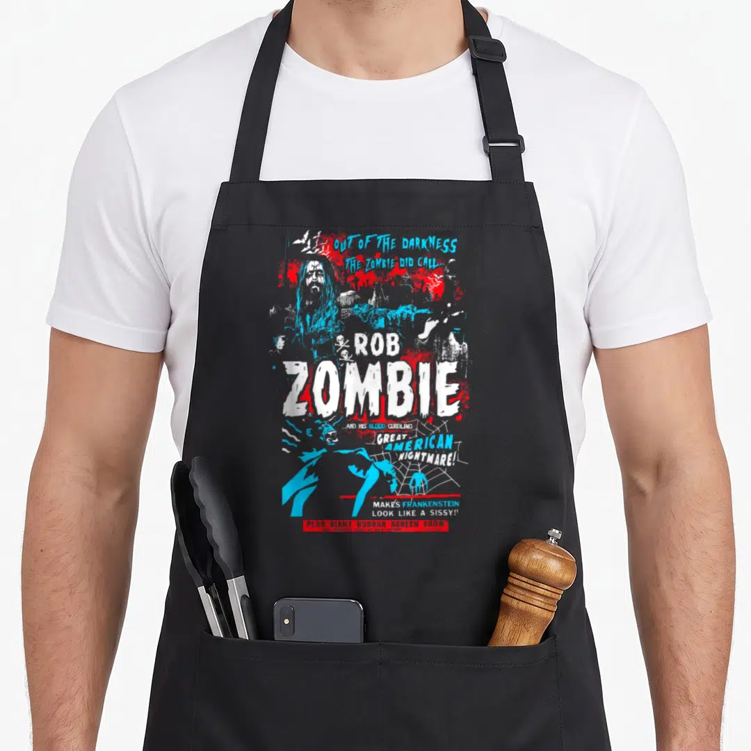 Rob zombie vibes apron - Distressed Rob Zombie poster with blood splatters, spider web, and horror show text in blue — shown on a black cotton canvas apron against a white background