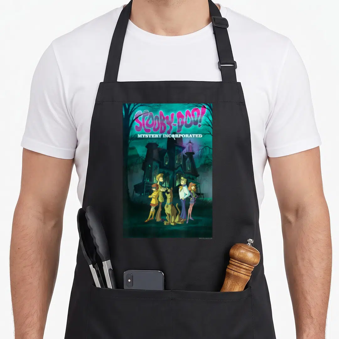 Incorporated mystery apron - Scooby-Doo Mystery Incorporated text and five characters in front of a dark teal haunted — shown on a black cotton canvas apron against a white background