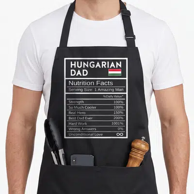 Hungarian nutrition pride apron - Hungarian Dad nutrition label with red white green flag and percentage stats — shown on a black cotton canvas apron against a white background
