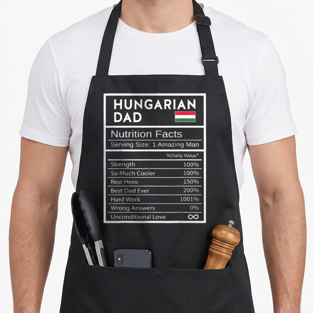 Hungarian nutrition pride apron - Hungarian Dad nutrition label with red white green flag and percentage stats — shown on a black cotton canvas apron against a white background