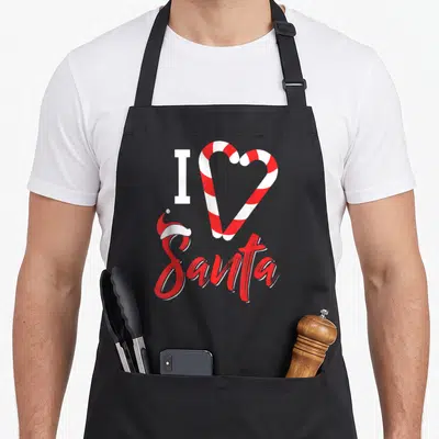 Christmas santa candy cane apron - I Santa text with two red white candy canes forming a heart and a small hat on the S — shown on a black cotton canvas apron against a white background